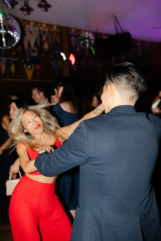 A young couple dancing at a wedding in Sausalito, California, while wearing sparkling glitter from the Glitter Bar