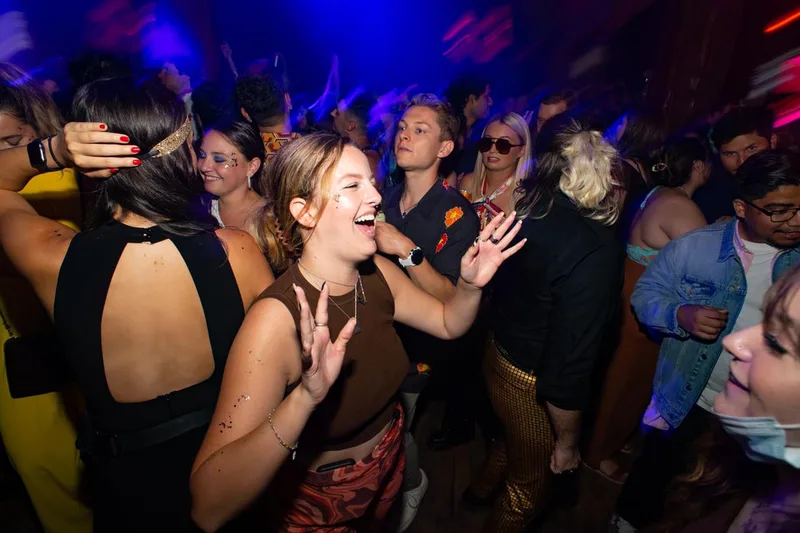 People dancing at a nightclub in San Francisco, Ca while wearing glitter and face paint