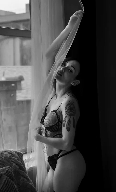 A woman in a boudoir photoshoot wearing body paint that looks like red and black lingerie in the SF Bay area